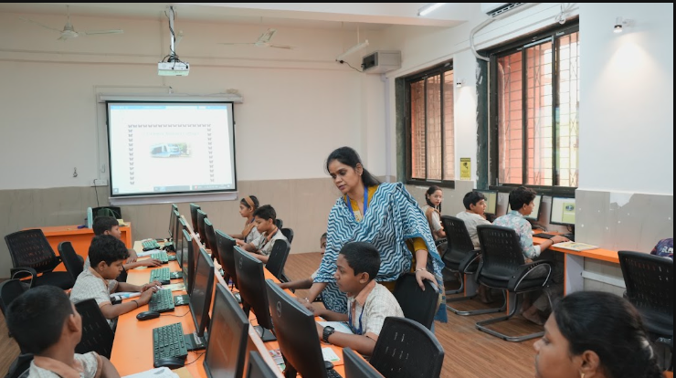 Students using computers with teacher